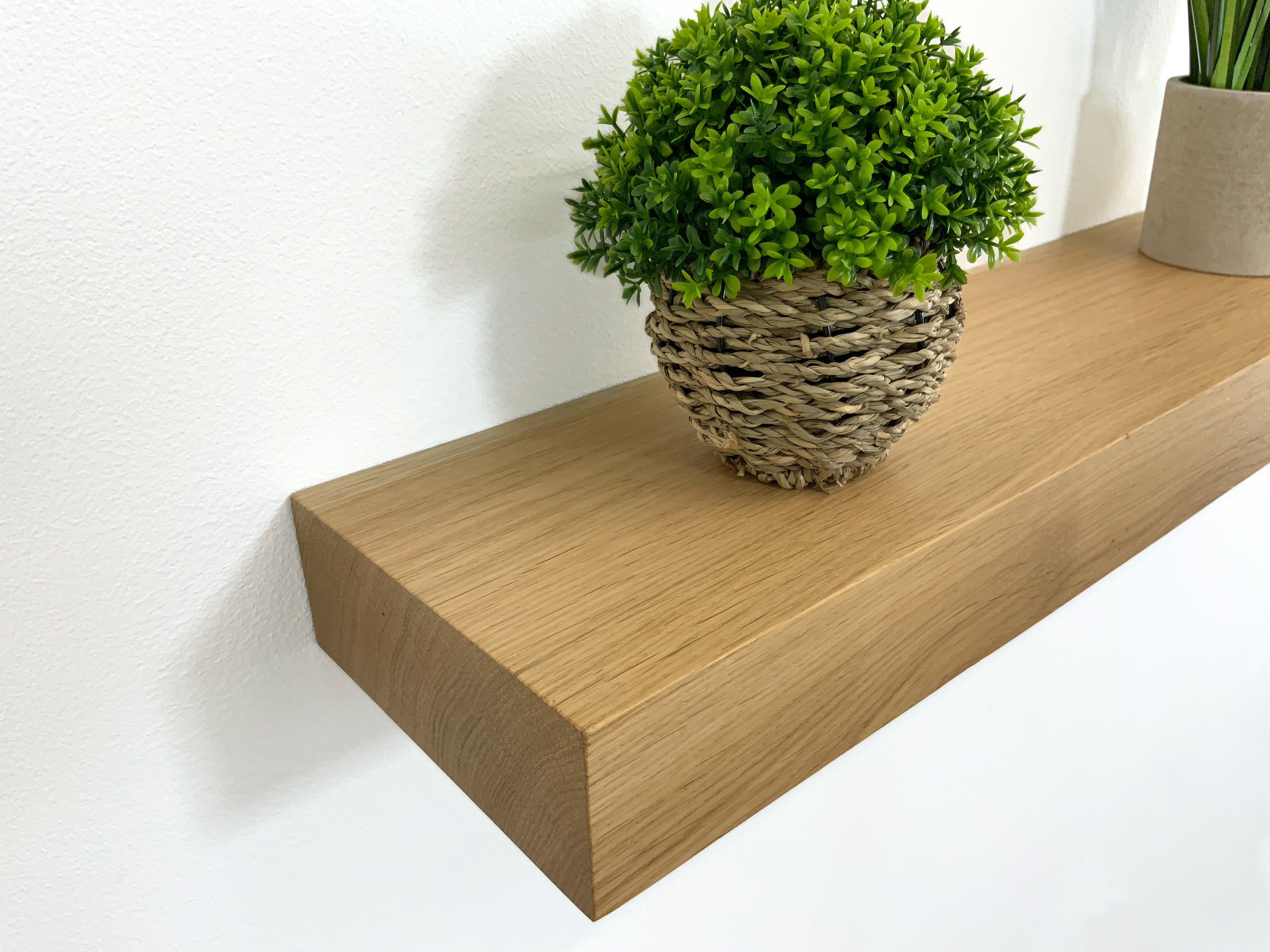 Chunky modern softened edge oak floating shelf close-up